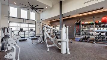 A gym with various exercise equipment, treadmills, and weightlifting stations.