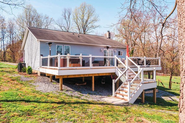 A two-story house with a deck and a staircase.