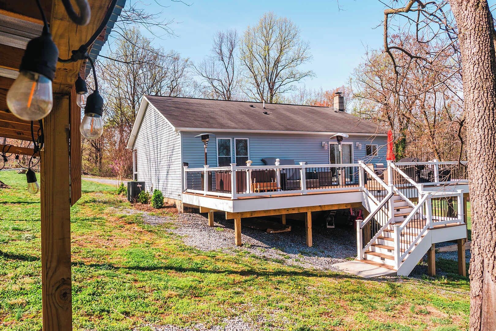 A house with a deck, a staircase, and a porch.