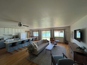 A spacious living area with a sofa, a dining table, and a kitchen with a refrigerator and cabinets. - Serene 3-bedroom house in Pagosa Springs perfect for your getaway (Pagosa Springs)