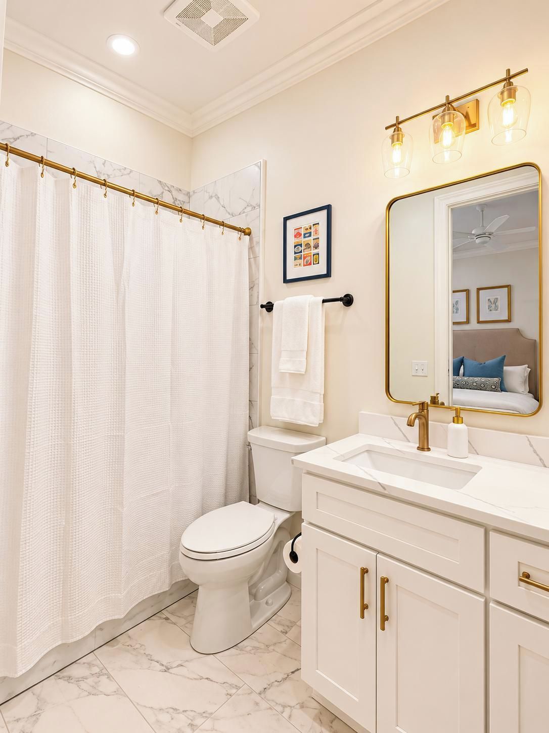 A bathroom with a toilet, a shower curtain, a sink, a mirror, and a towel rack.
