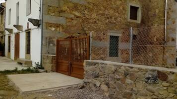 A rustic stone building with a wooden door and a small window.