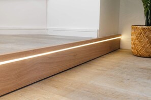 A wooden floor with a built-in light strip running along the edge. - West Kirby Apartment Walk to Marine Lake & beach (West Kirby)