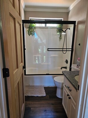 Ein Badezimmer mit Dusche, Toilette und Waschbecken.