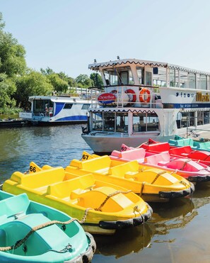 A row of colorful pedal boats docked at a waterfront. - Cosy 2 bed tce - walk to city centre (Chester)