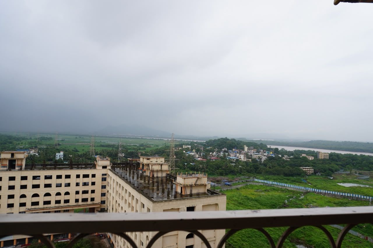 A view of a building with multiple floors and a balcony.
