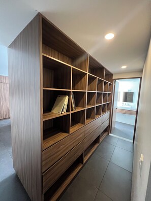 A large wooden bookshelf with multiple shelves and drawers, located in a hallway with a tiled floor. - Superb 2-bedroom apartment in welcoming Colonia del Valle neighborhood (Ciudad de México)