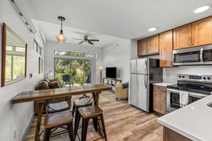 A modern kitchen with wooden cabinets, a stainless steel refrigerator, and a built-in oven. - Tranquil Riverfront Property Close to the Resort! Pet Friendly! (Steamboat Springs)