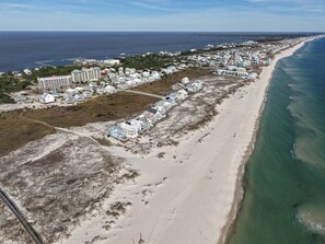 A coastal area with a beachfront hotel, sandy beach, and ocean view. - Flip Oasis Lockout · Coastal Comfort: Hot Tub, Foosball & Arcade (Gulf Shores)