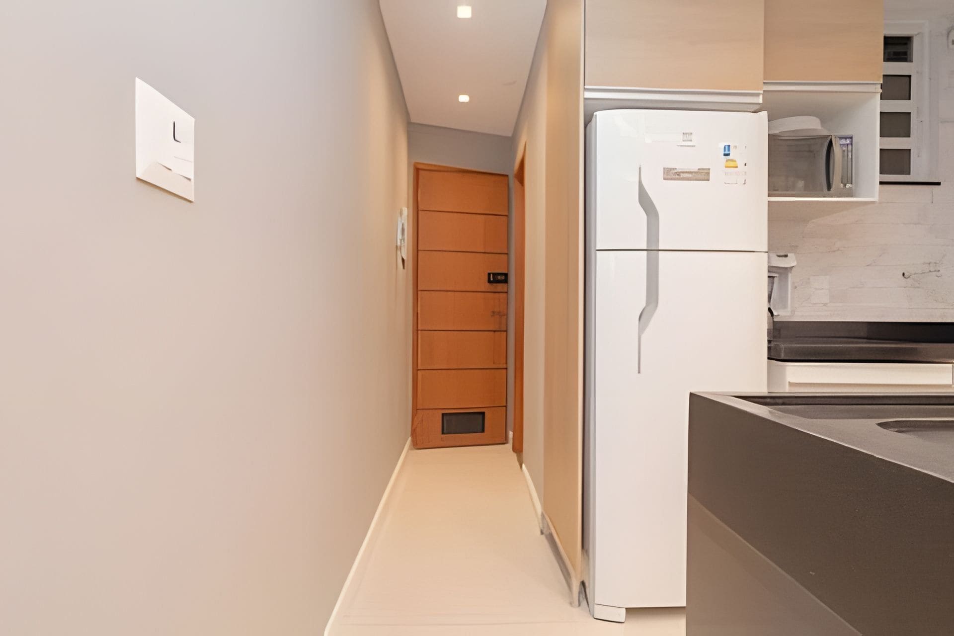 Eine moderne Küche mit Kühlschrank, Mikrowelle und Schränken.