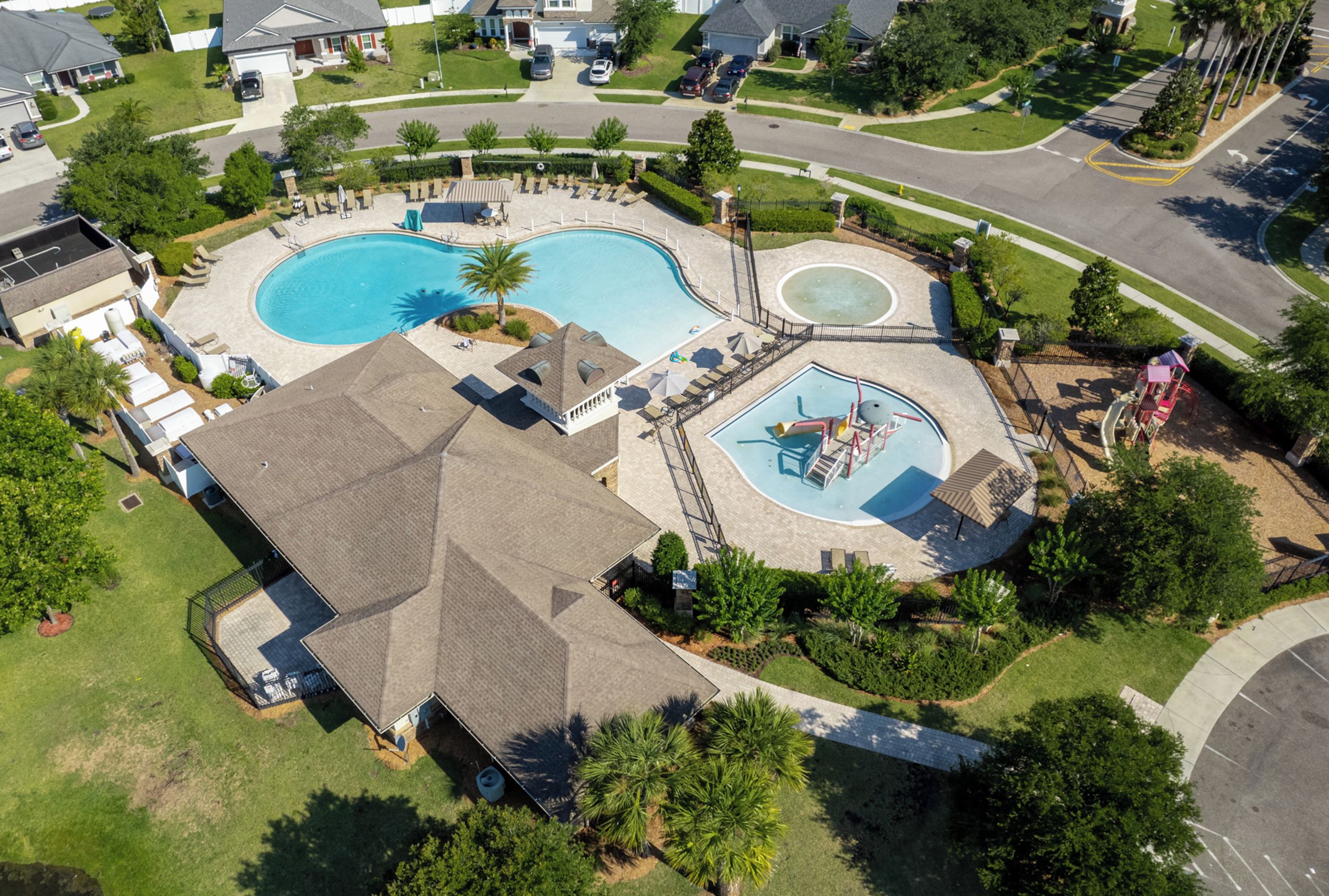 A residential property with a large swimming pool, a separate children's pool, and a play area.