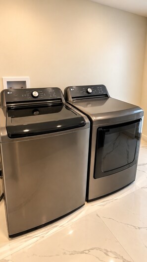 A compact washer and dryer unit with a control panel, placed on a tiled floor. - Casa Bella Miami 3 bedroom 2 full bathrooms in the Centr of Miami (Miami)