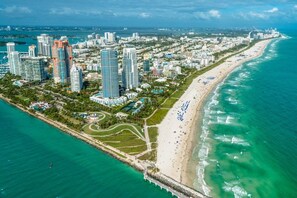 An aerial view of a coastal city with high-rise buildings, a beach, and a marina. - Casa Bella Miami 3 bedroom 2 full bathrooms in the Centr of Miami (Miami)