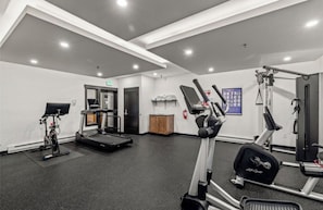 A gym with exercise equipment, a treadmill, and a weight machine. - Torian Plum Cozy 1-bedroom condo with AC Ski in/Ski Out Steamboat Springs (Steamboat Springs)