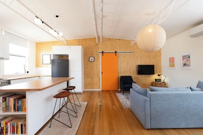 A modern interior with a kitchen, dining area, and living space.