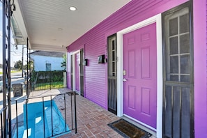 A house with a purple exterior, a front door, and a small porch with a blue mat. - 3BR, 2 Bath NOLA Home w/ Patio (New Orleans)