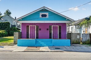 A two-story house with a blue front porch and a purple door. - 3BR, 2 Bath NOLA Home w/ Patio (New Orleans)