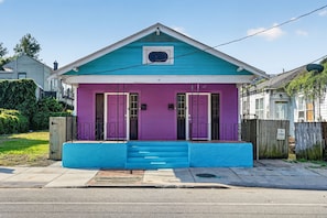 A two-story house with a blue front porch and a purple door. - Colorful New Orleans Home 3BR Near French Quarter (New Orleans)