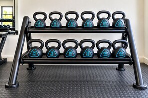 A rack of kettlebells with weights ranging from 4 kg to 24 kg. - Royal Golfview Stay  - Welcoming luxury 1-bedroom Apartment near OR Tambo (Boksburg)