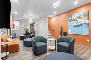 A modern living room with a poolside view, a dining area, and a kitchen. - Modern Palm Springs Retreat| 4 BR 4 Bath| Central (Pittsburgh)