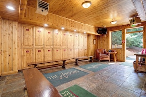 A wooden cabin interior with lockers, benches, and a view of the outdoors. - AN122 | Newly Listed | Winter Shuttle | Ski In/Out (Steamboat Springs)