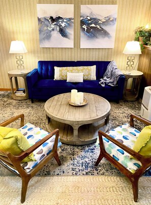 A room with a blue sofa, two armchairs, a round wooden coffee table, and two lamps. - Spacious Two Bedroom, WD in Unit Fireplace, Pet Friendly, Near Shopping (Shoreline)