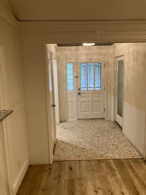 A hallway with a double door, a tiled floor, and a wooden floor. - Two bedroom Westlake house, very convenient to downtown and Zilker / ACL (Austin)