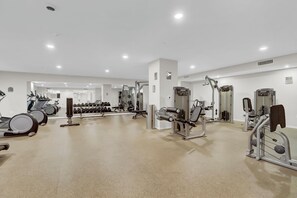 A gym with treadmills, dumbbells, and weight machines. - PremiumStays: Modern : Central to sports, arena, Theater : Loft : Parking : Gym (Cleveland)