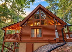 A log cabin with a balcony, large windows, and a chimney. - A Piece of Paradise| Pigeon Forge Cabin| Hot Tub (Sevier County)