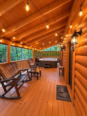 A wooden deck with outdoor seating and a hot tub. - A Piece of Paradise| Pigeon Forge Cabin| Hot Tub (Sevier County)