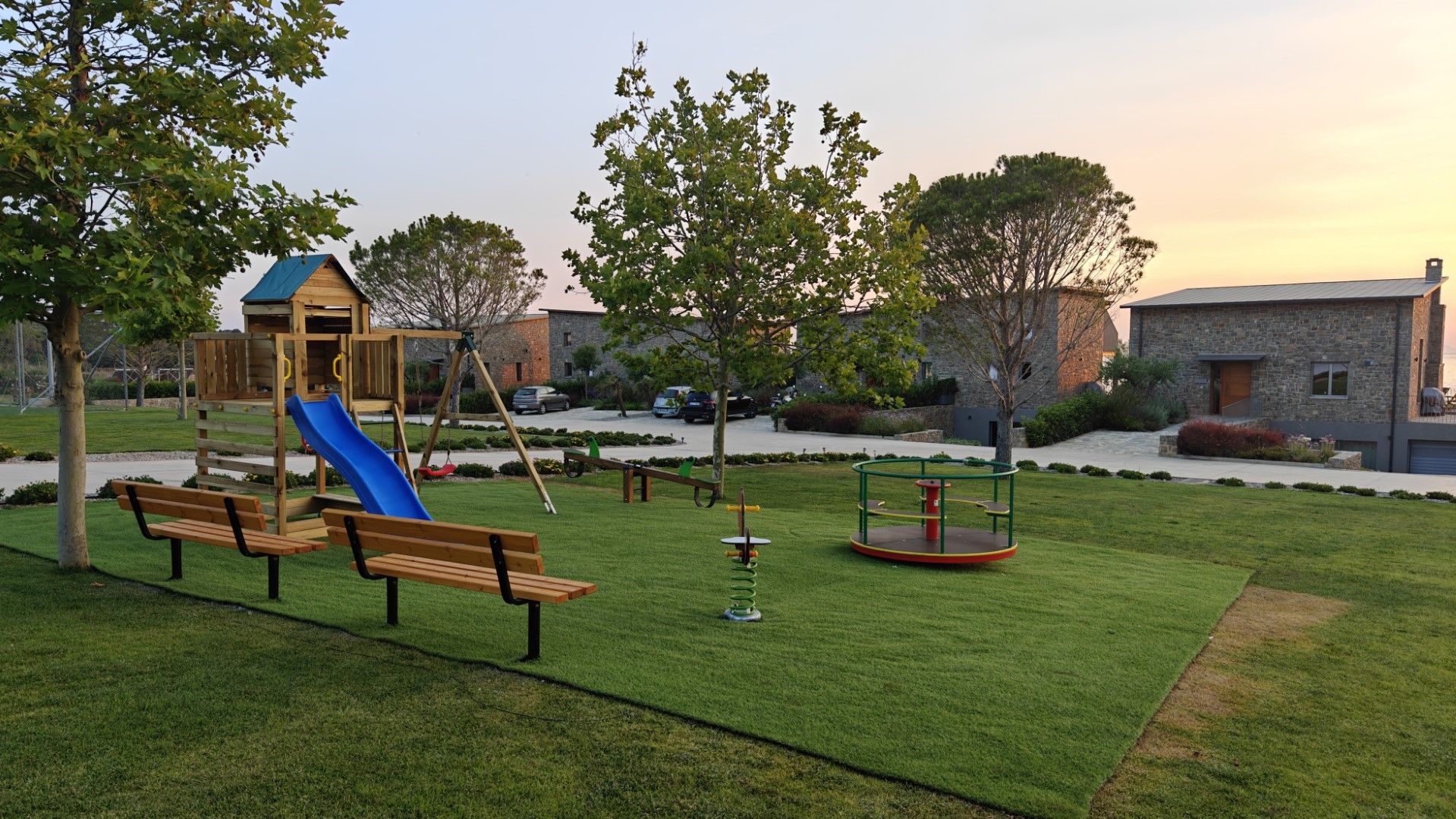 A playground with a slide, swings, and a climbing structure.