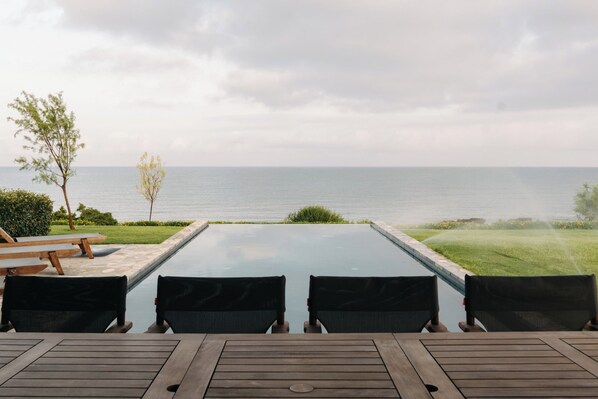 An outdoor seating area with a view of the sea.