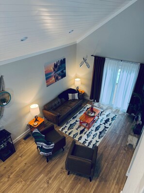 A living room with a sofa, armchairs, a coffee table, and a patterned rug. - 9139 Orange -2-bedroom w/ Loft - Melton Hill Lake & Marina -Close to downtown UT (Oak Ridge)