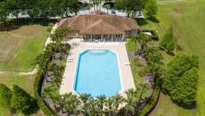 An aerial view of a property with a swimming pool surrounded by a landscaped area and palm trees. - Anazing new 5BR / 3 bath    2131 Derwent Dr (Davenport)
