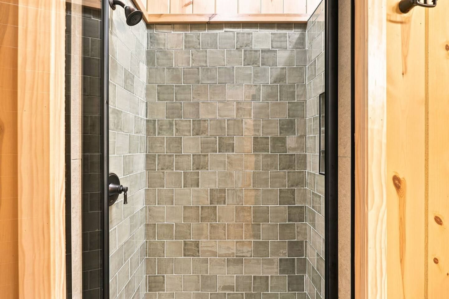 Guests can rinse off after a day on the water in this spacious tiled walk-in shower.