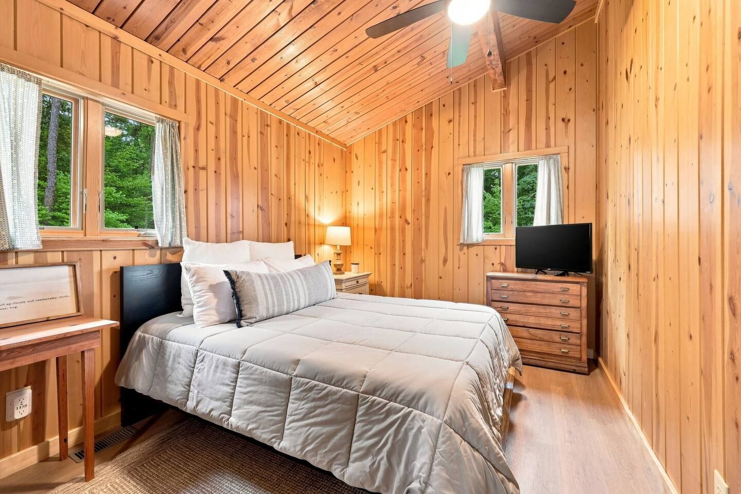 Guests can unwind and catch a show on the TV atop the dresser before settling into bed for the night.