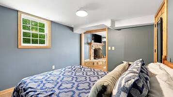 Guests can watch a movie from bed on the mounted TV above the little fireplace mantle.