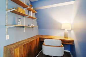 A corner room with a desk, chair, shelves, and a lamp. - Private Resort w/ Heated Pool, Pickleball Court, Firepit... Near IMG and Beach! (Bradenton)