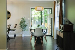 A dining area with a table, chairs, a hanging light fixture, and a potted plant. - Outdoorsy, Sauna, Ice Bath, Pets OK, 10 min Dtwn (Raleigh)