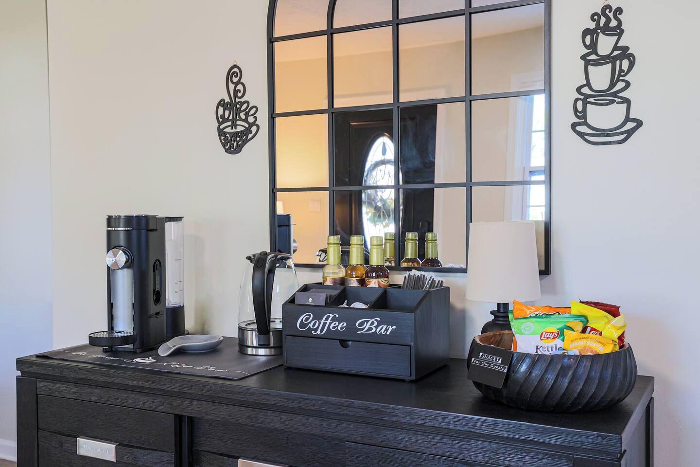 A coffee station with a coffee machine, a kettle, and a coffee bar sign.