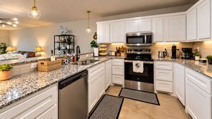 A modern kitchen with white cabinets, stainless steel appliances, and granite countertops. - NEW..Walk to UMHB & Downtown & 3BR & Pets Welcome (Belton)