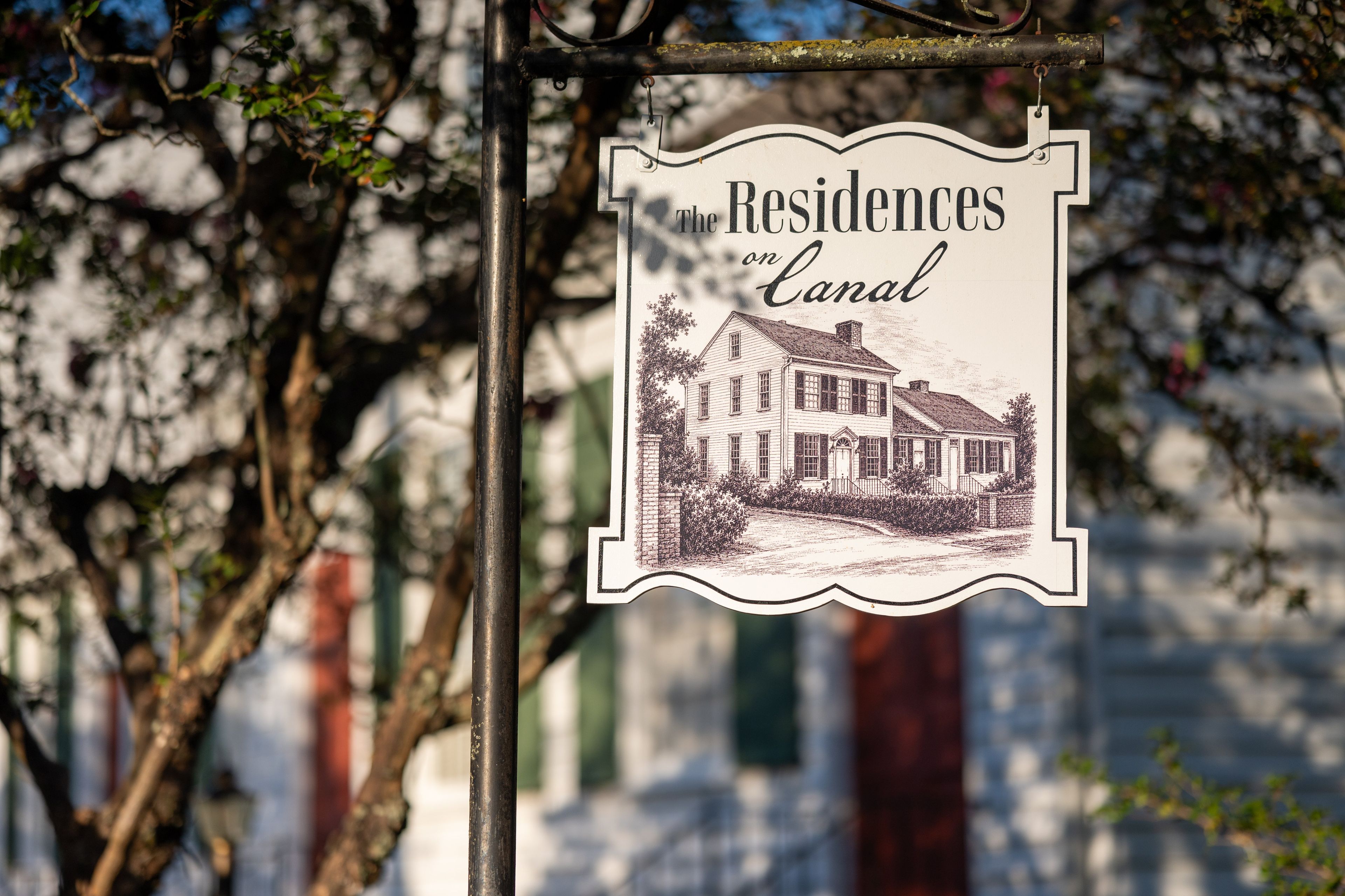 Une enseigne portant l’inscription « Résidences sur le canal » et illustrée d’un dessin de maison.