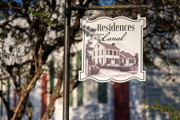 A sign with the text 'Residences on Canal' and an illustration of a house.