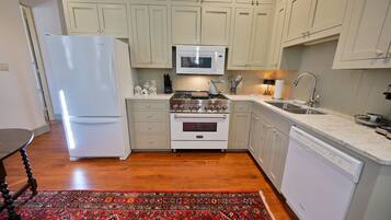 A modern kitchen with a refrigerator, stove, oven, microwave, and dishwasher.