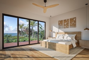 Ein Schlafzimmer mit einer großen Glasschiebetür, die auf einen Balkon mit Blick auf das Meer und Palmen führt.