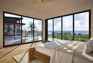Quarto com uma cama grande, vista para uma piscina e varanda com vista para o oceano.