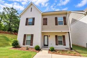 A two-story residential building with a front door, a small porch, and a number '430' on the facade. - The Grove Getaway Standalone Townhome 4BR/4.5BA Near Ole Miss (Oxford)