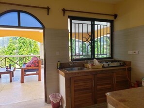 A kitchen with a window, a sink, and a stove. - Bella Breeze1 - Diani Beach, Kenya (Diani Beach)