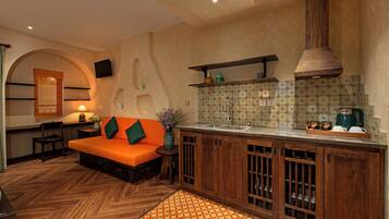 A kitchen with a wooden countertop, a built-in oven, and a sink.