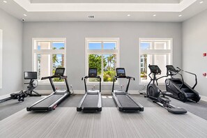 A gym with three treadmills, one elliptical, and a stationary bike, all with digital screens. - 1BR King Suite - Pool, Gym, Games & Dog Friendly (Middleburg)